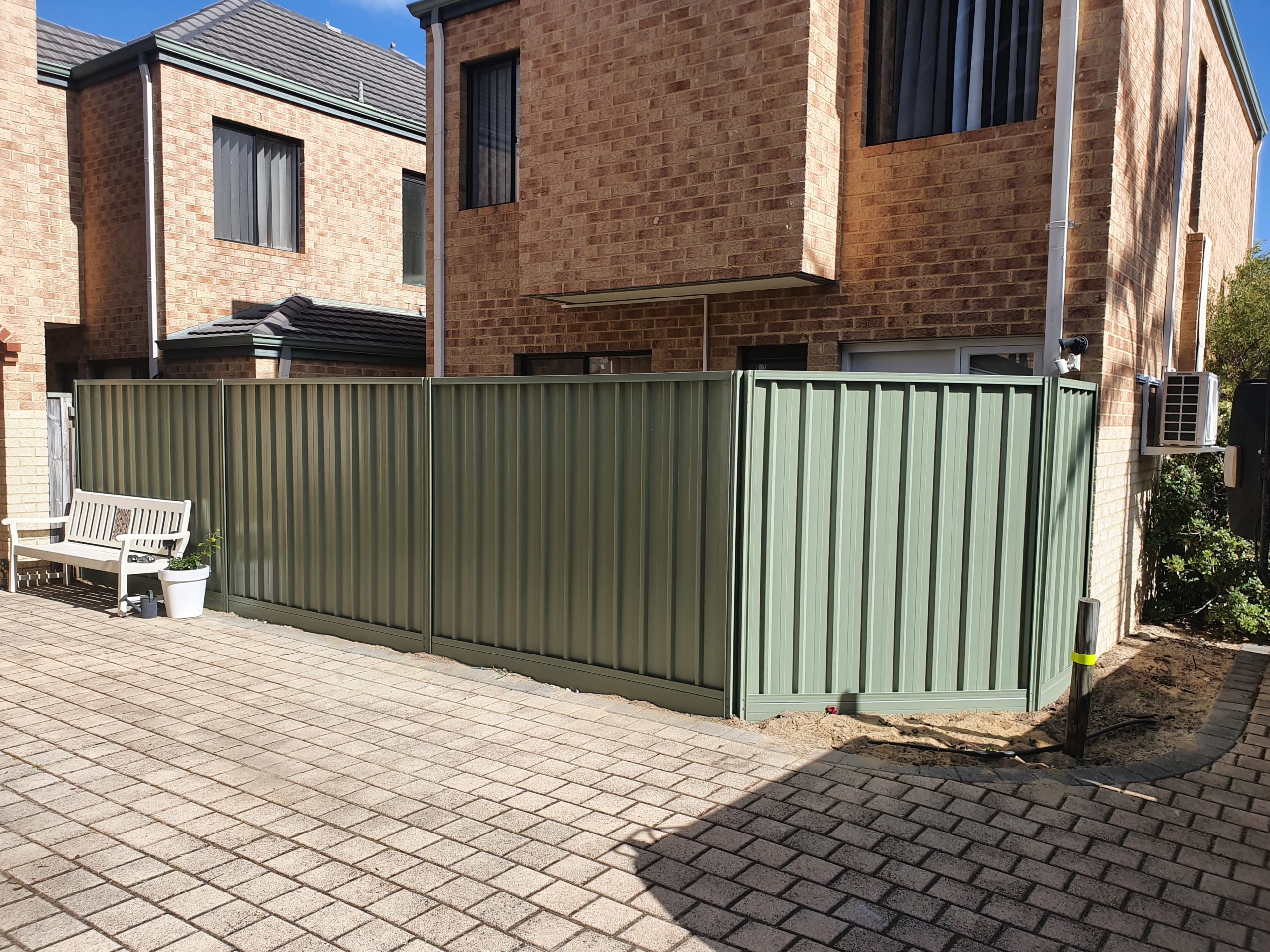 Colorbond fence installation in Perth, featuring sturdy steel panels available in a range of colors to match the surrounding landscape or house exterior. Colorbond fences are known for their durability, low maintenance, and ability to withstand harsh weather conditions, making them an ideal choice for residential and commercial properties in Perth. The fence installation team can customize the design and height of the fence to meet the specific needs and preferences of the property owner, providing a practical and attractive boundary for the property