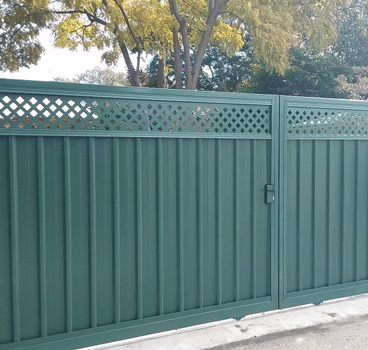 A green gate installed in Perth, providing a stylish and secure entrance to the property. The gate features a sleek design with clean lines and a smooth finish, and is made of durable materials such as Colorbond steel or aluminum. The green color adds a touch of personality and complements the surrounding landscape or house exterior. The gate can be customized to fit any size or shape of the entrance, providing a functional and attractive addition to the property.