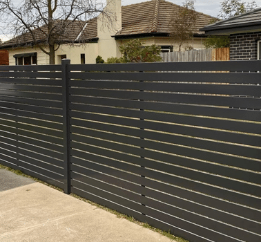 Slat fencing installed in Perth, featuring evenly spaced horizontal slats made of durable materials such as timber or aluminum. This type of fencing offers privacy and security while allowing for airflow and visibility, and comes in a variety of colors and sizes to match the surrounding environment or house exterior. Slat fencing is a popular choice for its low maintenance and long-lasting durability, making it ideal for residential and commercial properties in Perth