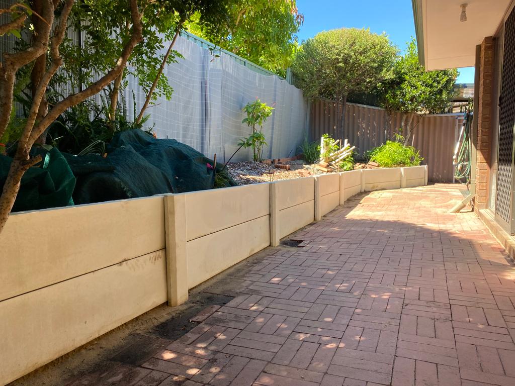post and panel retaining wall installation